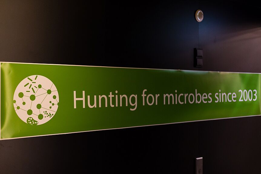 Banner with the motto of DOME "Hunting for microbes since 2003"