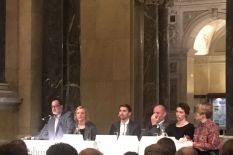 People of the panel discussion sitting at a table